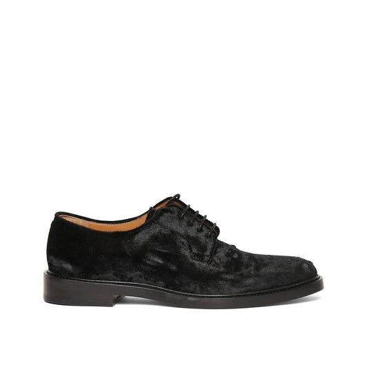 Black suede dress shoe on a white background