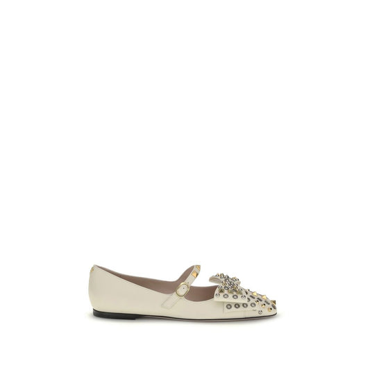 White flat shoe with embellishments on a white background