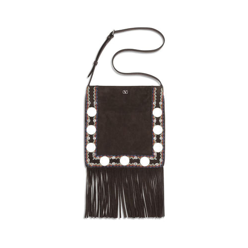 Black handbag with fringe and decorative elements on a white background