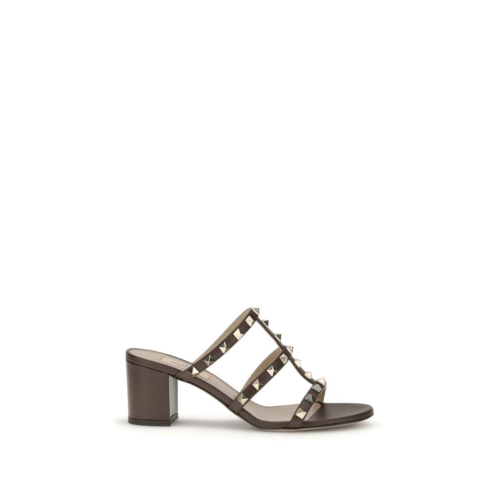 Brown sandal with studded design on a white background