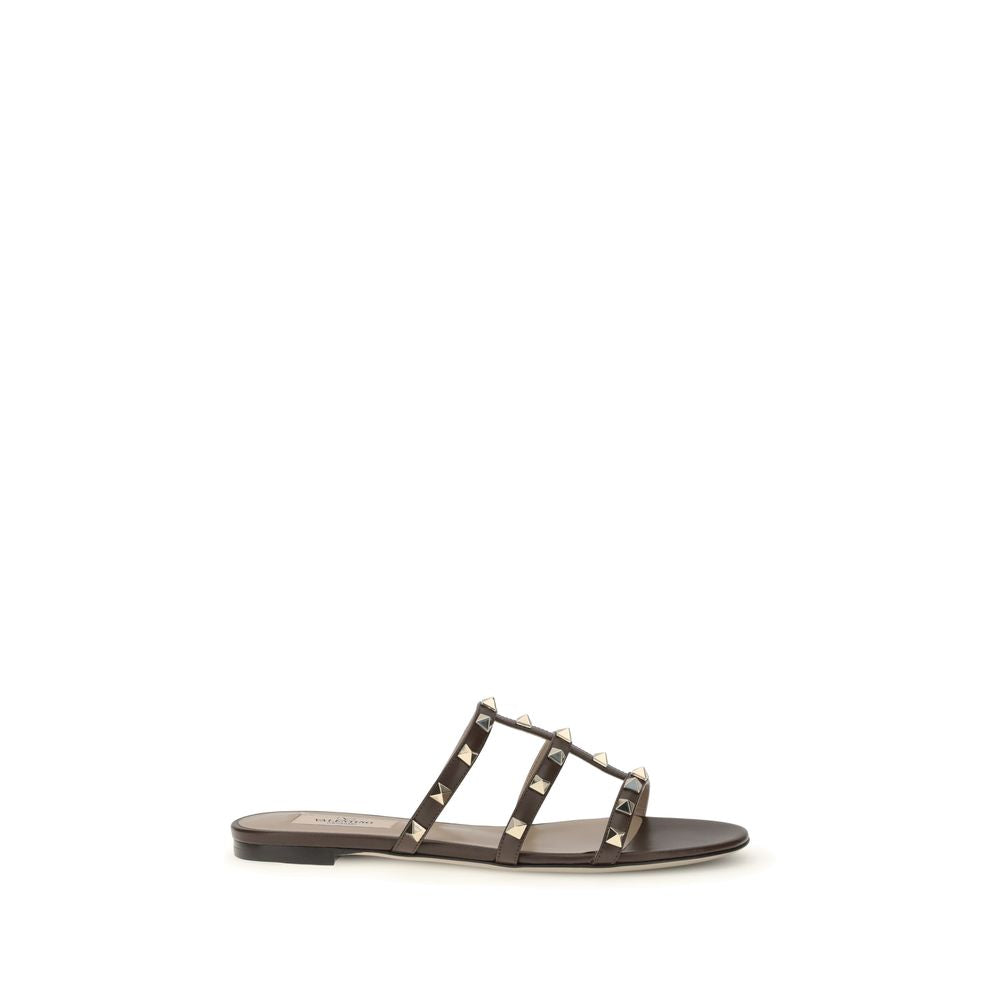 Black sandal with silver straps on a white background